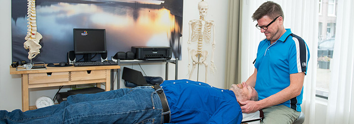 Chiropractor Amsterdam NH J.G. Drewry Adjusting Patient With Neck Pain